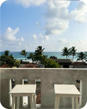 Private Balcony View Overlooking Palm Trees and Ocean Waves
